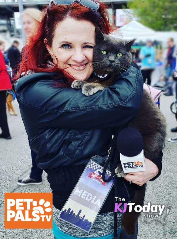 KJ holding a cat and mic at KJ Today Show and Pet Pals TV